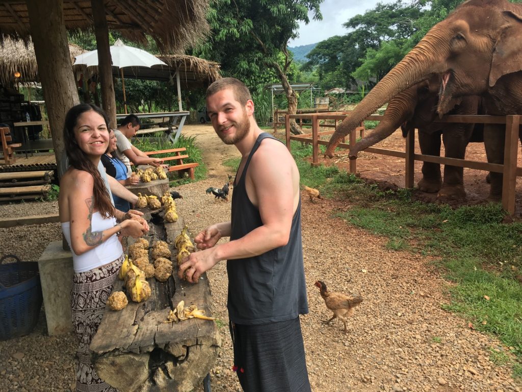 PHOTO OF US SMILING PREPARING FOOD