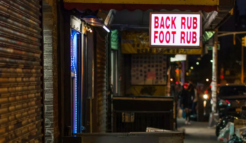 Sign for Back Rub and Foot Rub in dark street